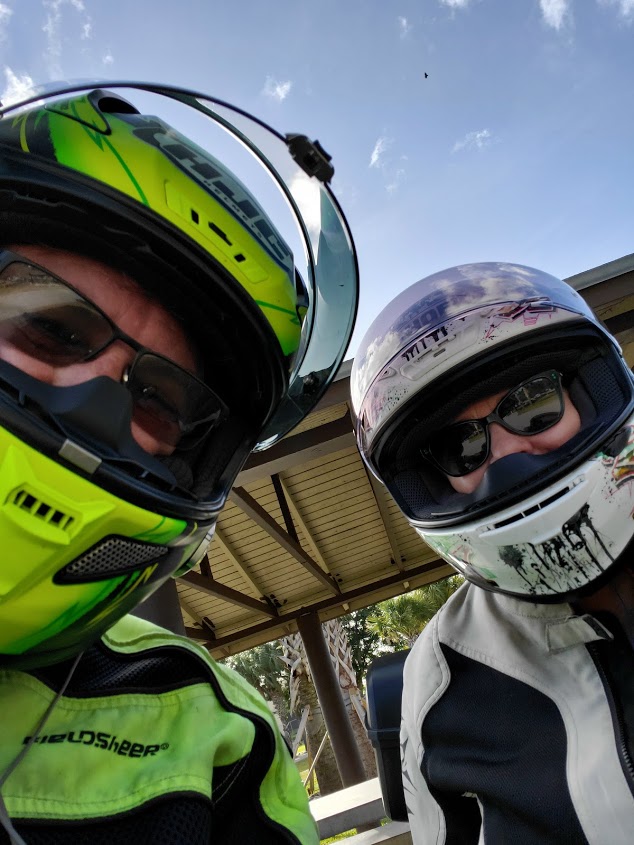 Mark Turkel and Lorraine Turkel wearing motorcycle helmets